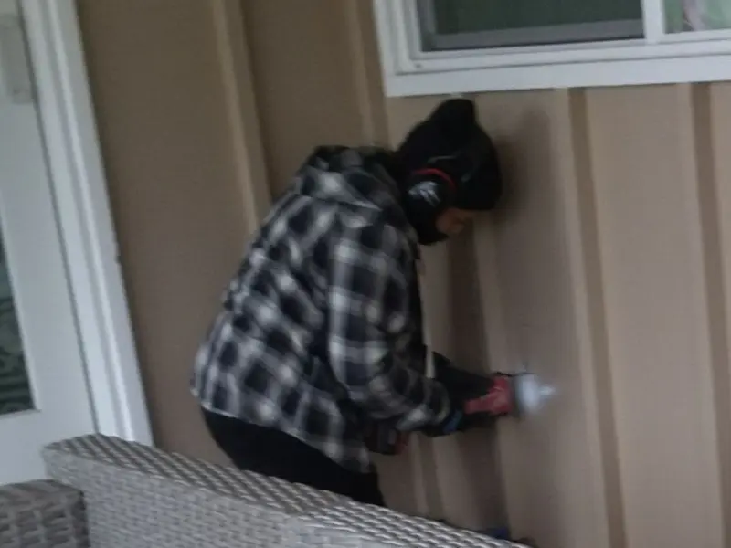Professional electrician installing an exterior outlet in Providence
