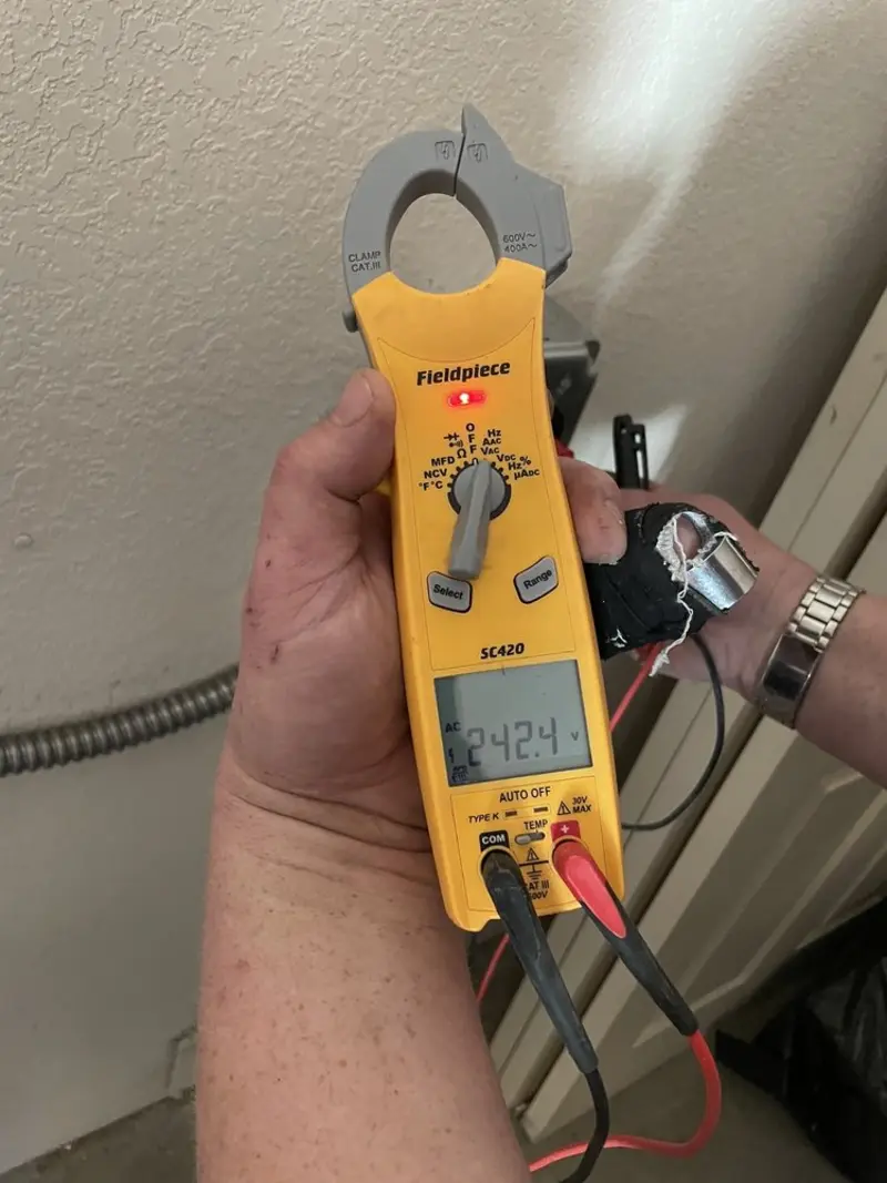Voltage testing with clamp meter during Outlet Installation in Providence